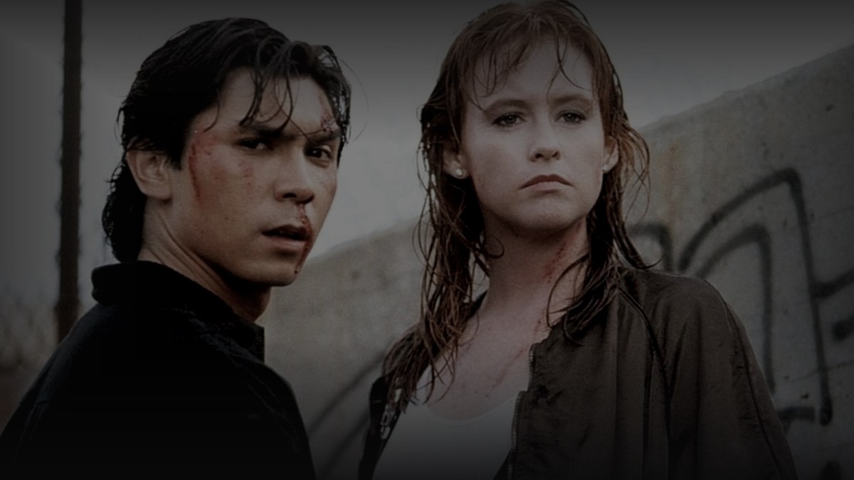 Still from The First Power (1990) — 16:9 still from Letterboxd (the 1200x675 crop variant), baked through scripts/bake_dark_photo.py at default factor, mean brightness to be verified after bake. source: the canonical still for the film.